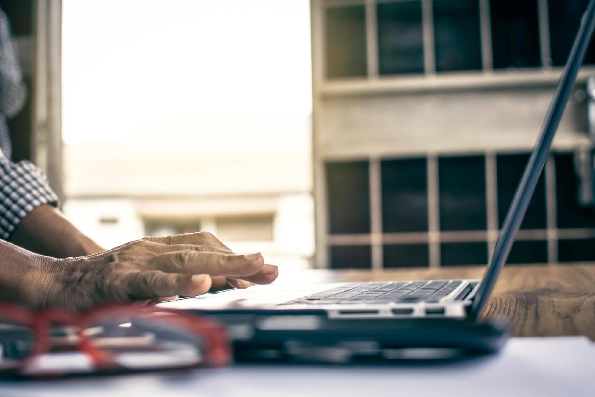 Professional accountant working at desk with skyline in background